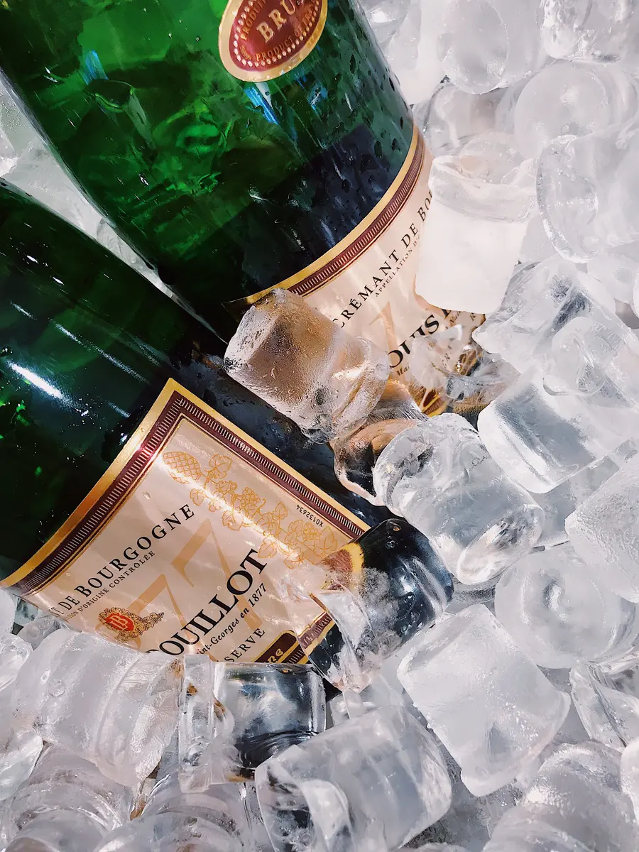 Wine and beverage bottles chilling in ice